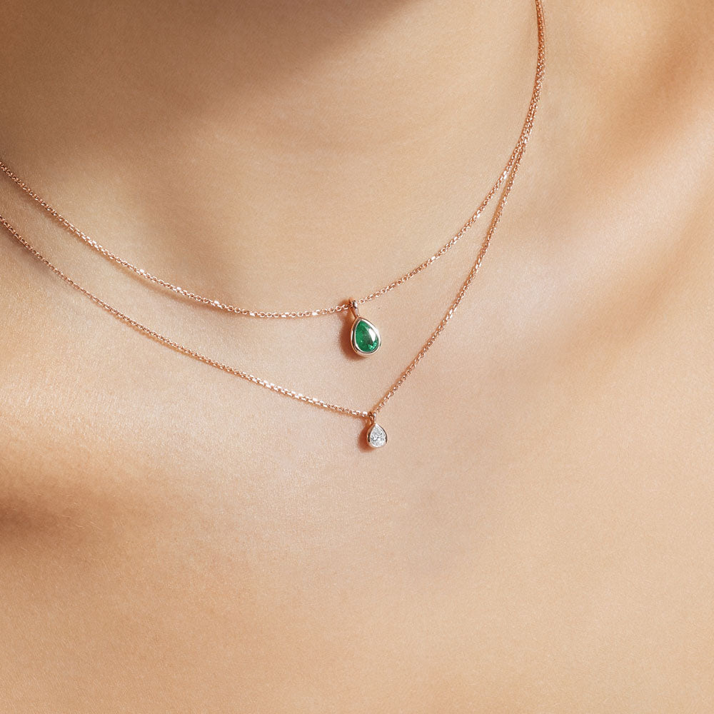 Model wearing Jewellers District's Bezel Set Pear-Cut Emerald Pendant Necklace in 10k Rose Gold #2