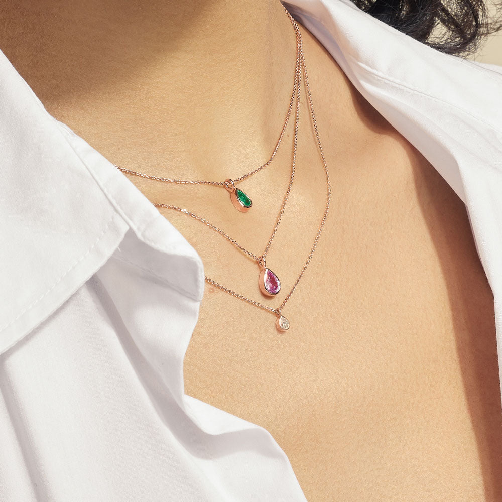 Model wearing Jewellers District's Bezel Set Pear-Cut Emerald Pendant Necklace in 10k Rose Gold #3