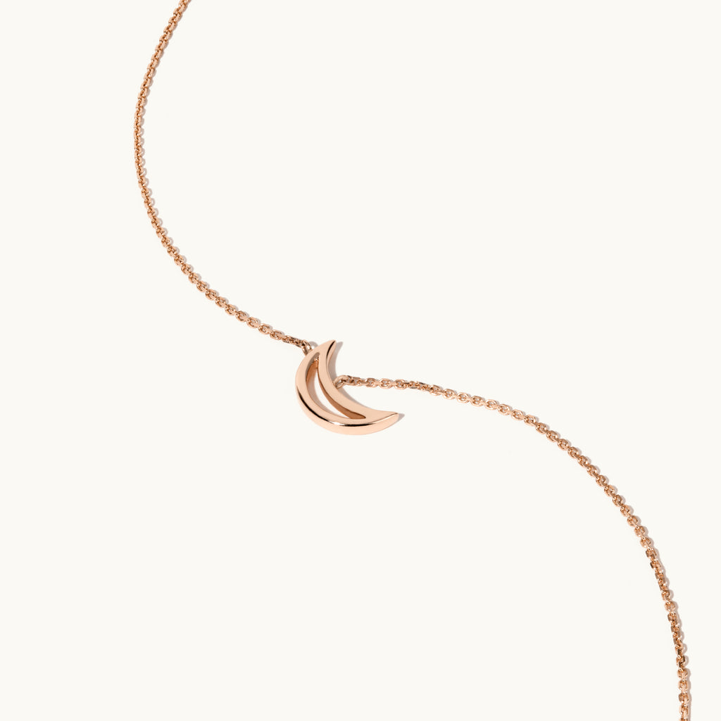 Angled view of Jewellers District's Gold Moon Pendant Necklace in 10k Rose Gold