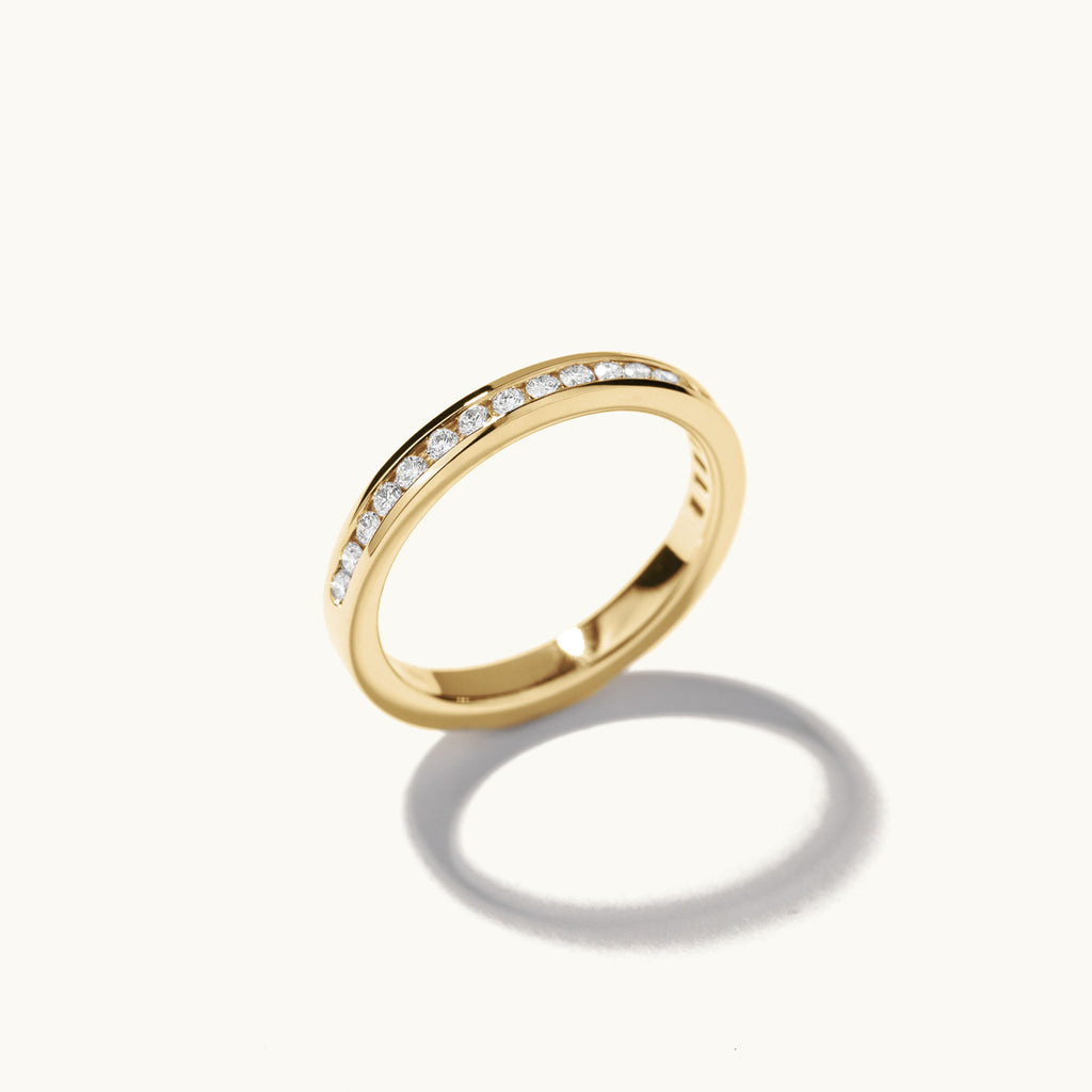 Profile view of Jewellers District's Channel-Set Diamond Pavé Wedding Ring in 14k Yellow Gold