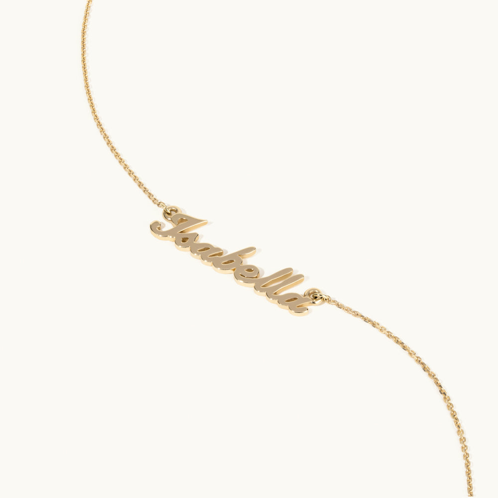 Angled view of Jewellers District's Personalizable Gold Name Necklace in 14k Yellow Gold